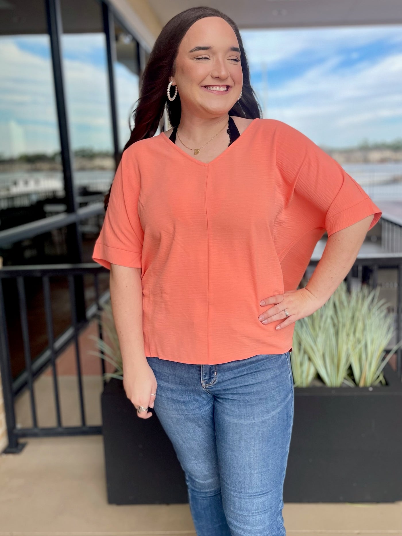 KORT IN CORAL ANNALISA V-NECK DOLMAN TOP FRONT VIEW SMILING
