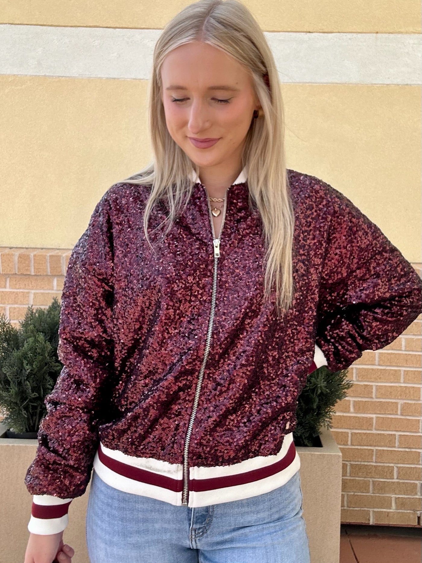 AVA LOOKING DOWNWARDS IN JACKET