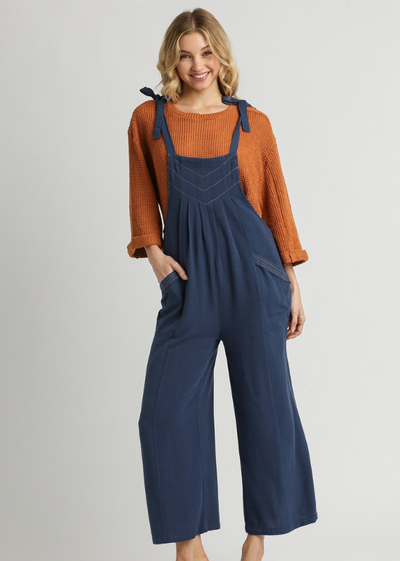 MODEL IN KYLEE PLEATED JUMPSUIT NAVY FRONT VIEW