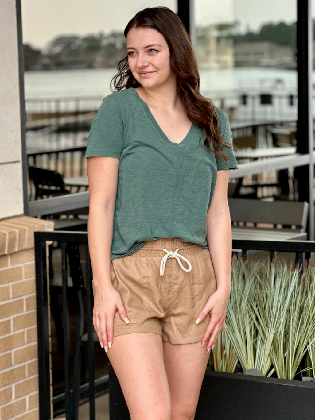 MEGAN SMILING TO THE LEFT IN SHORTS