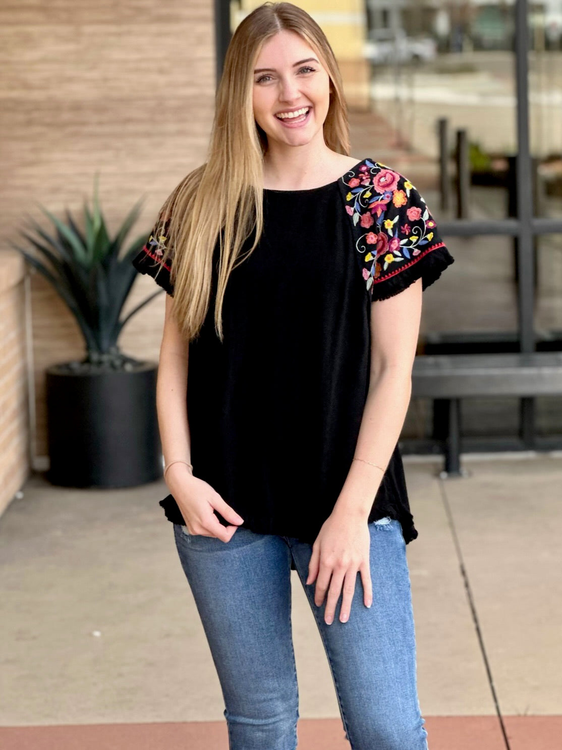 Lexi in black blouse front view smiling