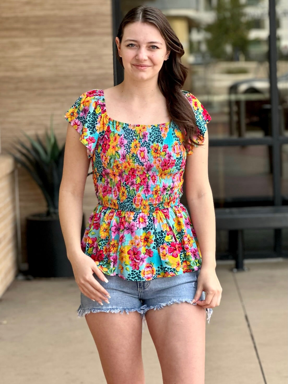 Megan in multi floral blouse front view smiling