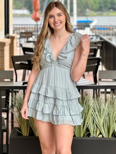 Lexi in blue dress front view holding sleeve
