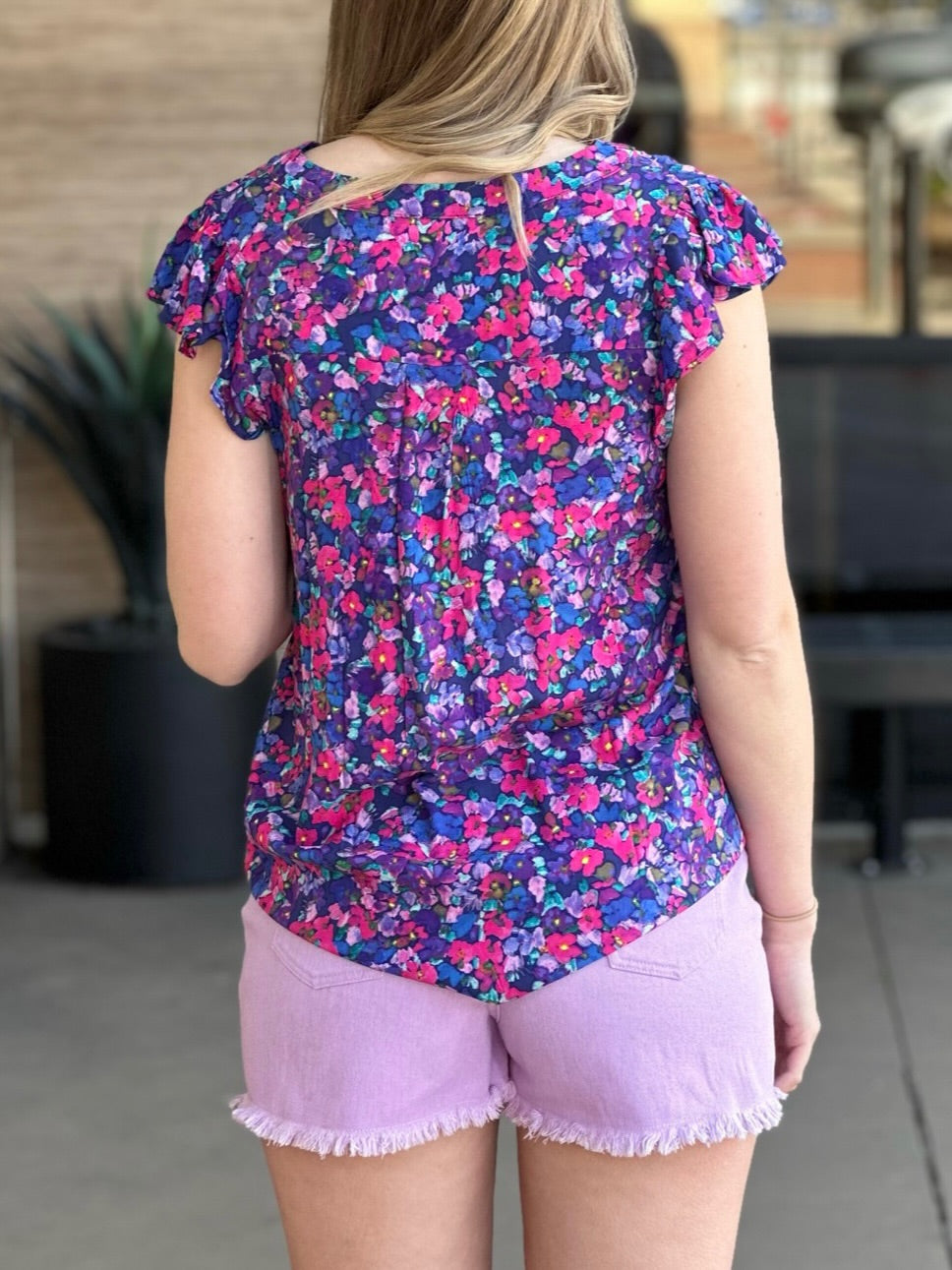 Lexi in multi blouse back view