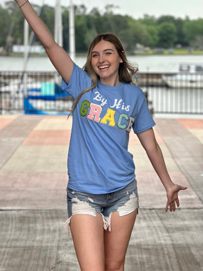 Lexi in carolina blue tee front view hands up