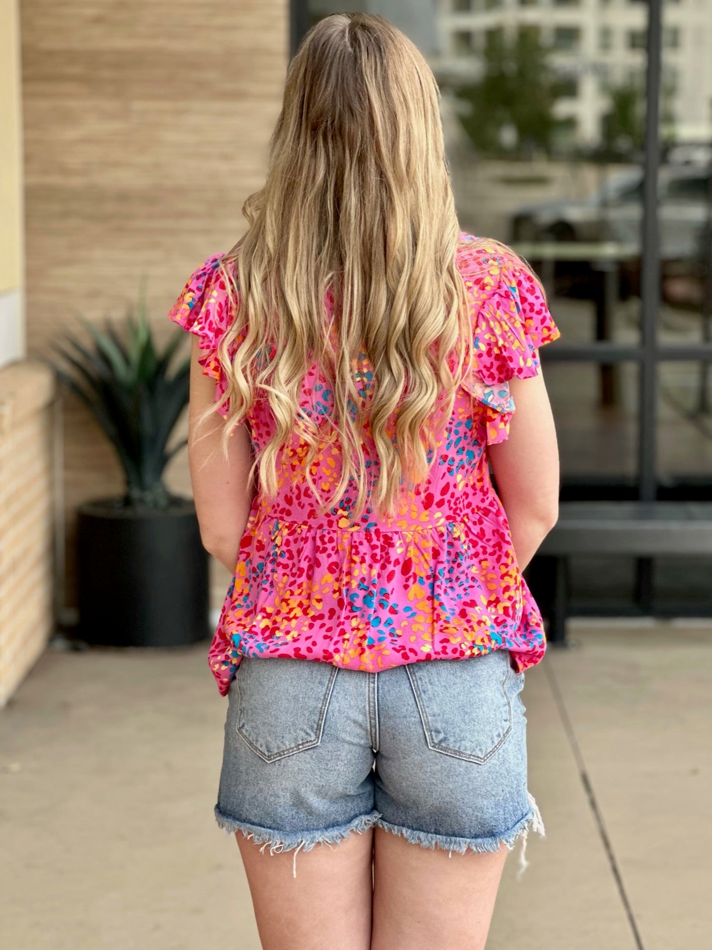 Lexi in hot pink blouse back view