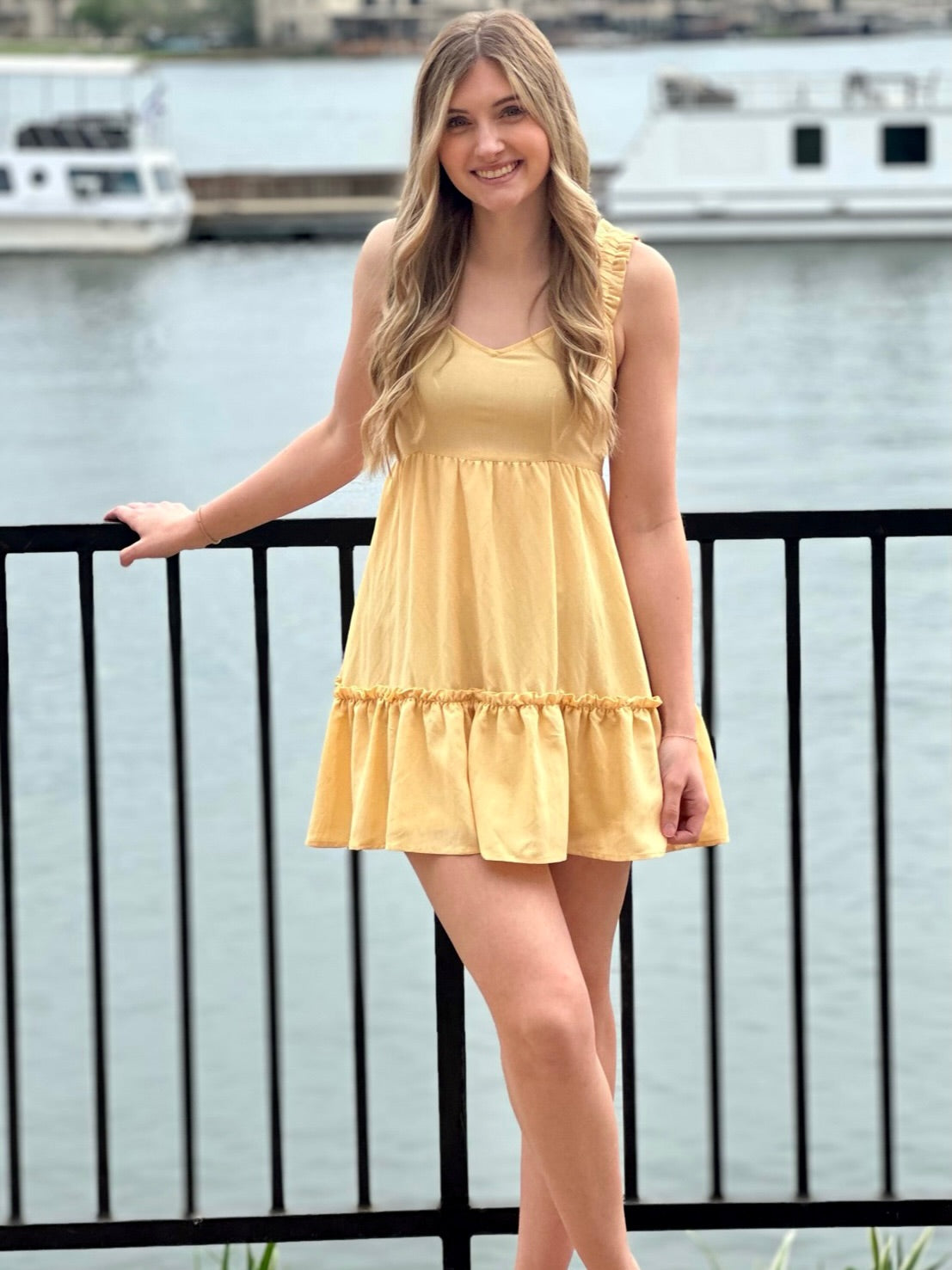 Lexi in yellow dress front view hand down 