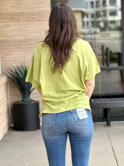 Megan in pale olive top back view