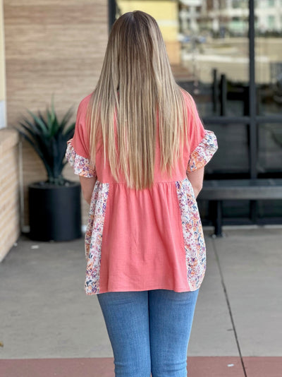 Lexi in coral top back view