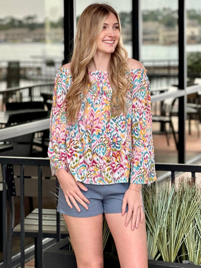 Lexie in multi blouse looking to the side