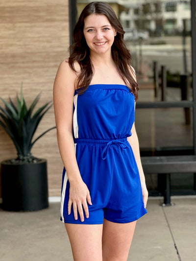 Megan in royal blue jumpsuit front view smiling
