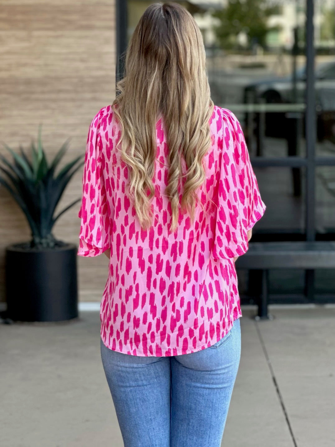 Lexi in hot pink blouse back view