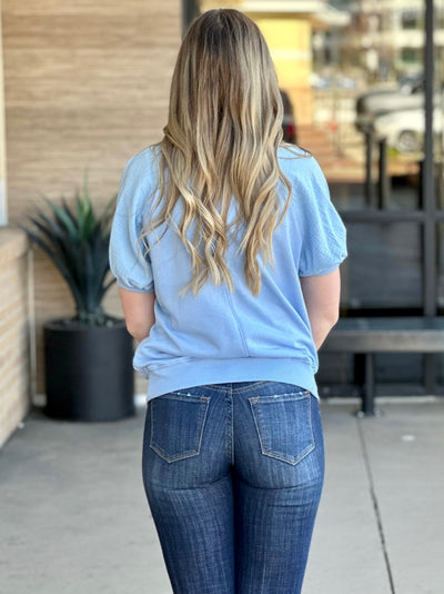 Lexi in sky blue top back view