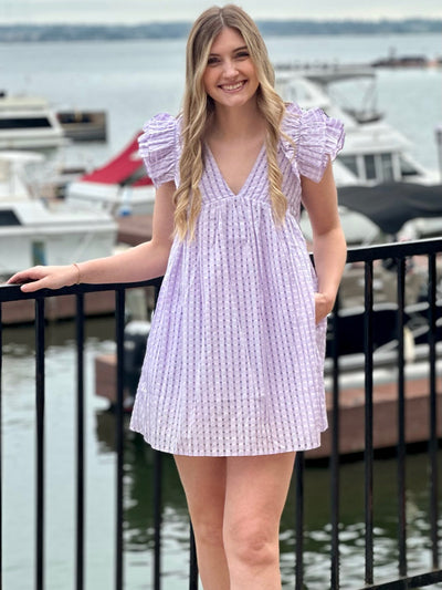 Lexie in lavender dress hand in pocket