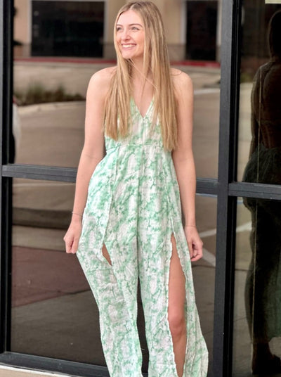 Lexi in mint jumpsuit looking to the side