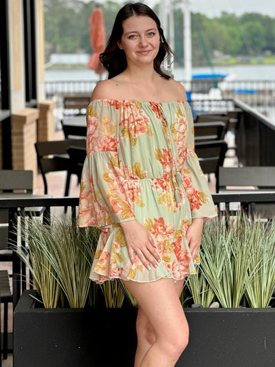 Megan in sage romper front view hands down