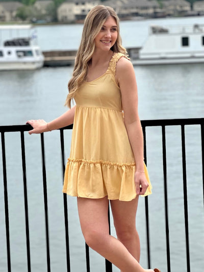 Lexi in yellow dress looking to the side