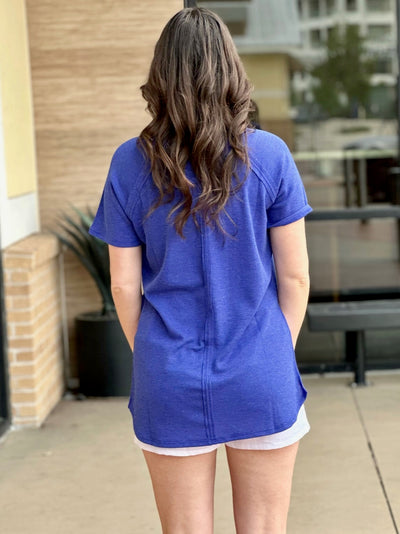Megan in bright blue top back view