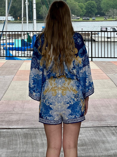 Lexi in blue romper back view
