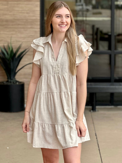 Lexi in oatmeal dress looking to the side smiling