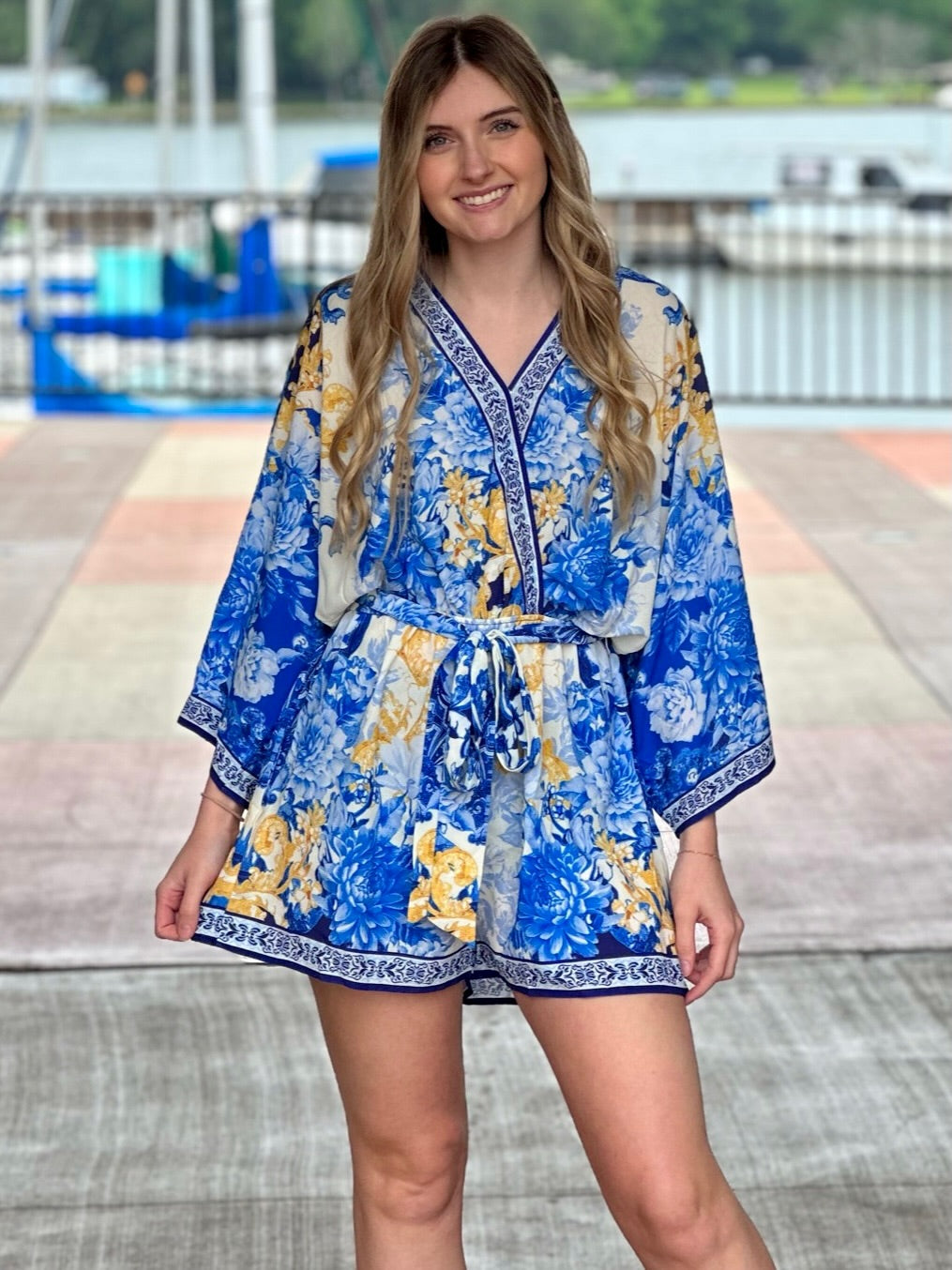 Lexi in blue romper front view smiling