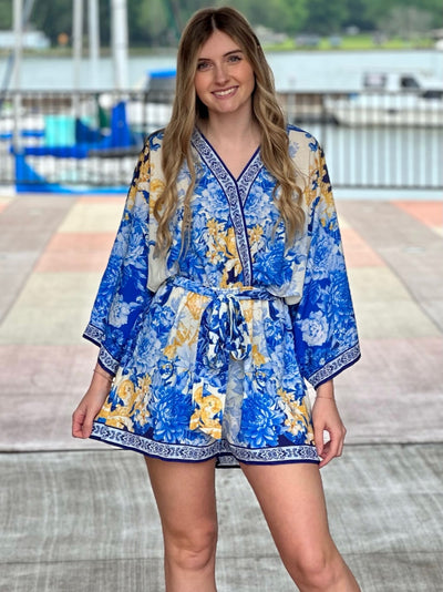 Lexi in blue romper front view smiling