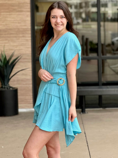 Megan in clear blue romper side view smiling