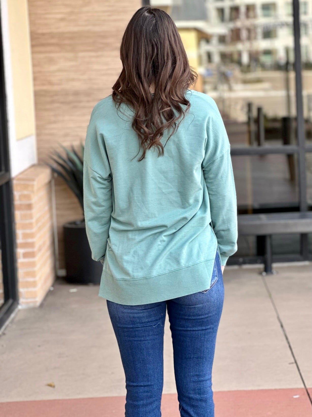 MEGAN IN GREEN SWEATER BACK VIEW