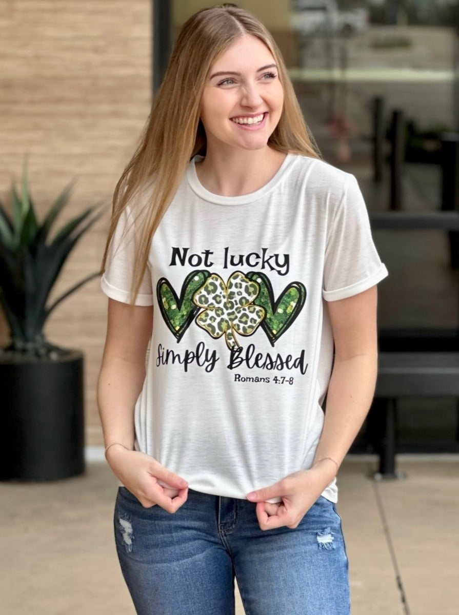 Lexi in simply blessed graphic tee front view holding top 