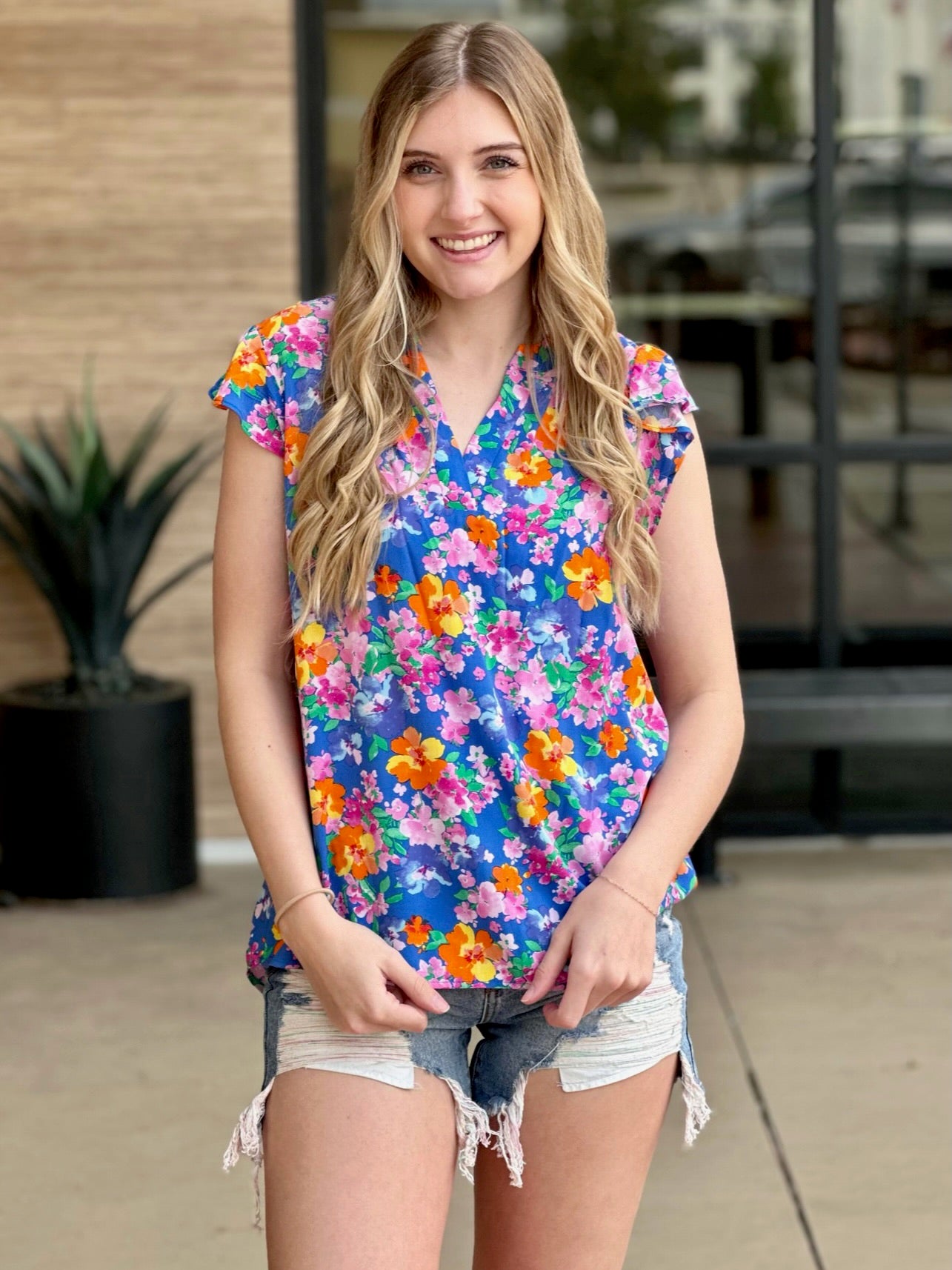 Lexi in royal multi blouse holding top 