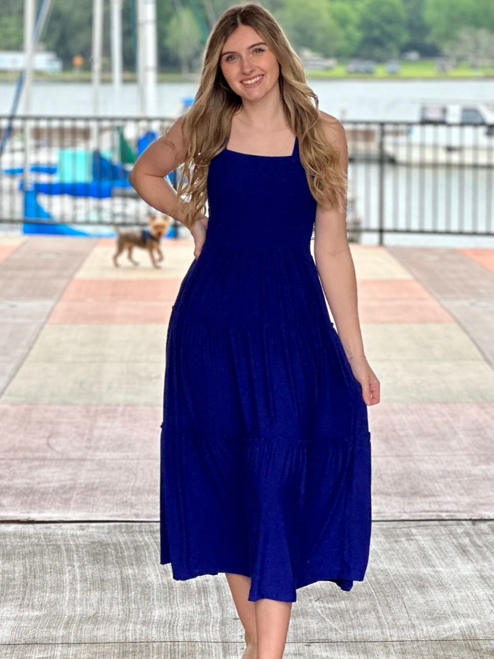 Lexi in bright blue midi dress front view hand on hip