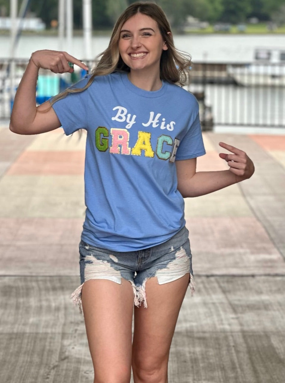 Lexi in carolina blue tee front view pointing at shirt