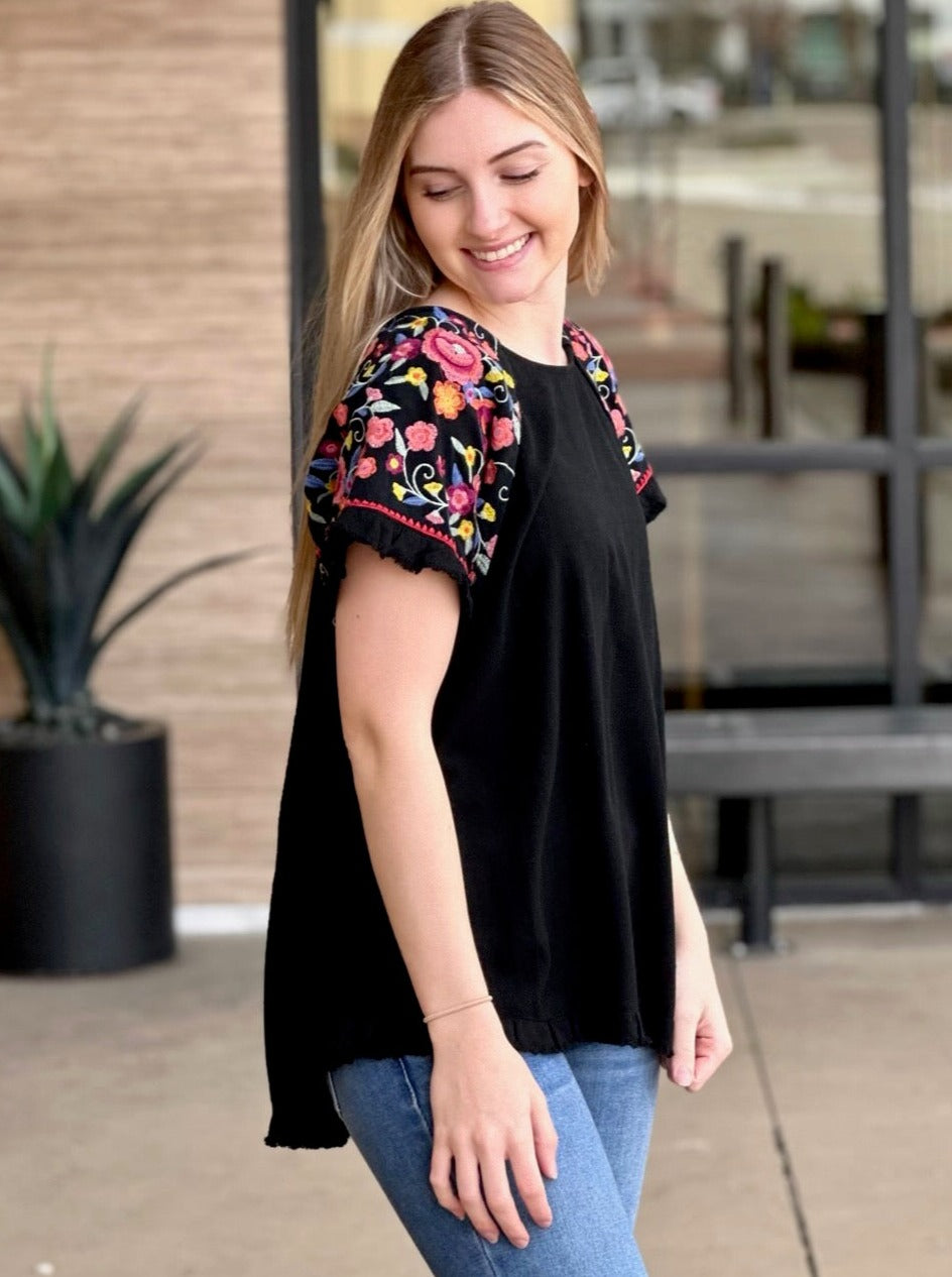 Lexi in black blouse side view looking down