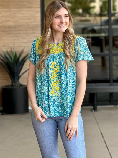 Lexi in aqua blouse front view smiling