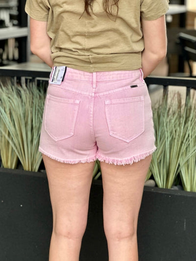 Megan in pink shorts back view