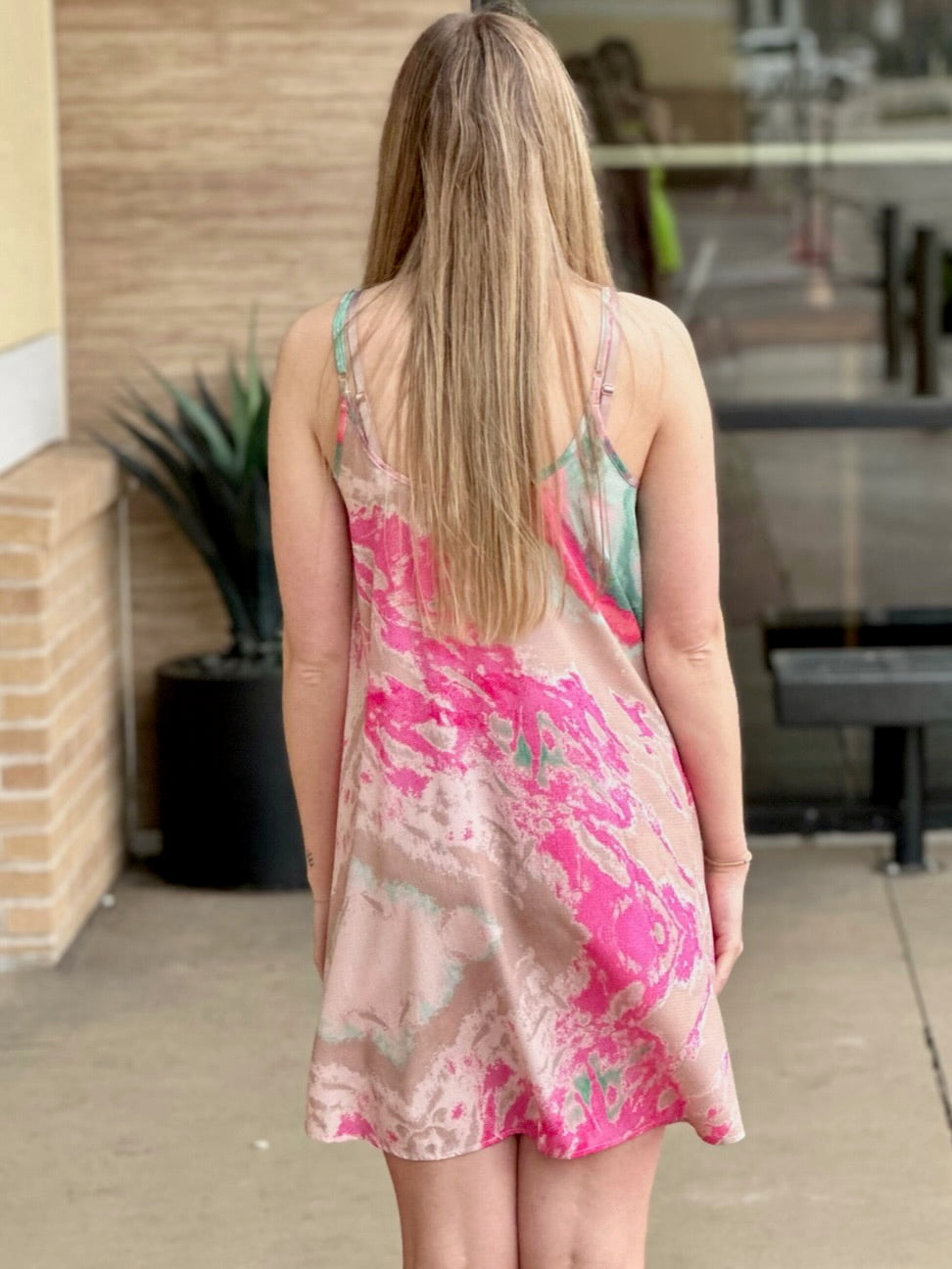 Lexi in pink/green dress back view