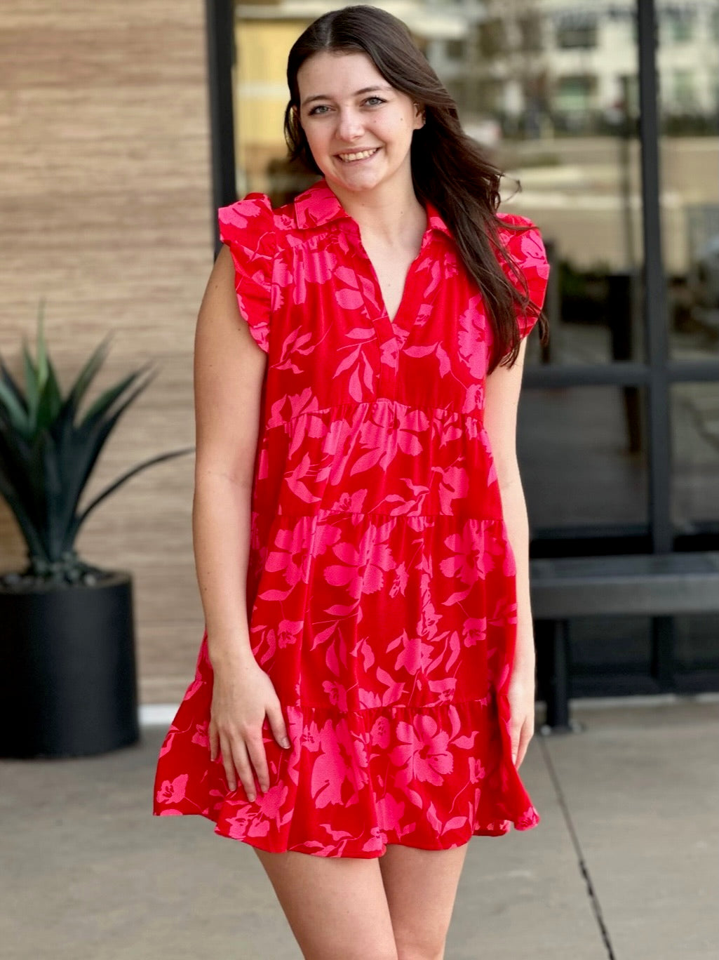 Megan in red mix dress front view smiling hands down