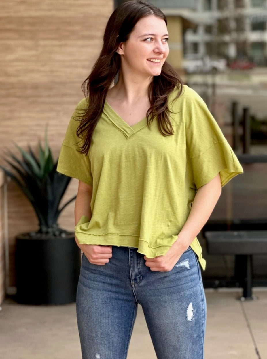 Megan in pale olive top looking to the side
