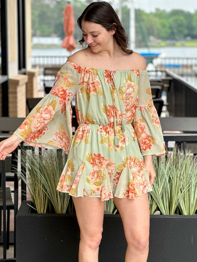 Megan in sage romper front view looking at sleeve