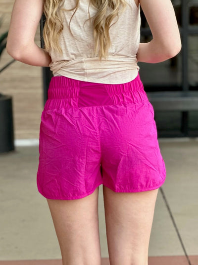 Lexi in hot pink shorts back view