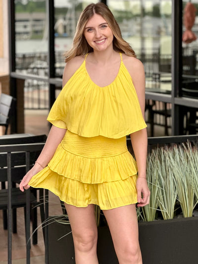 Lexi in yellow romper hand out