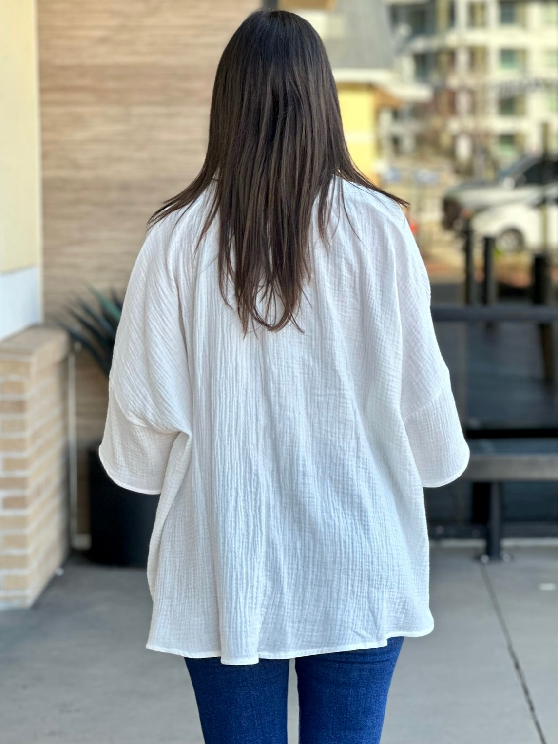 Megan in off white top back view