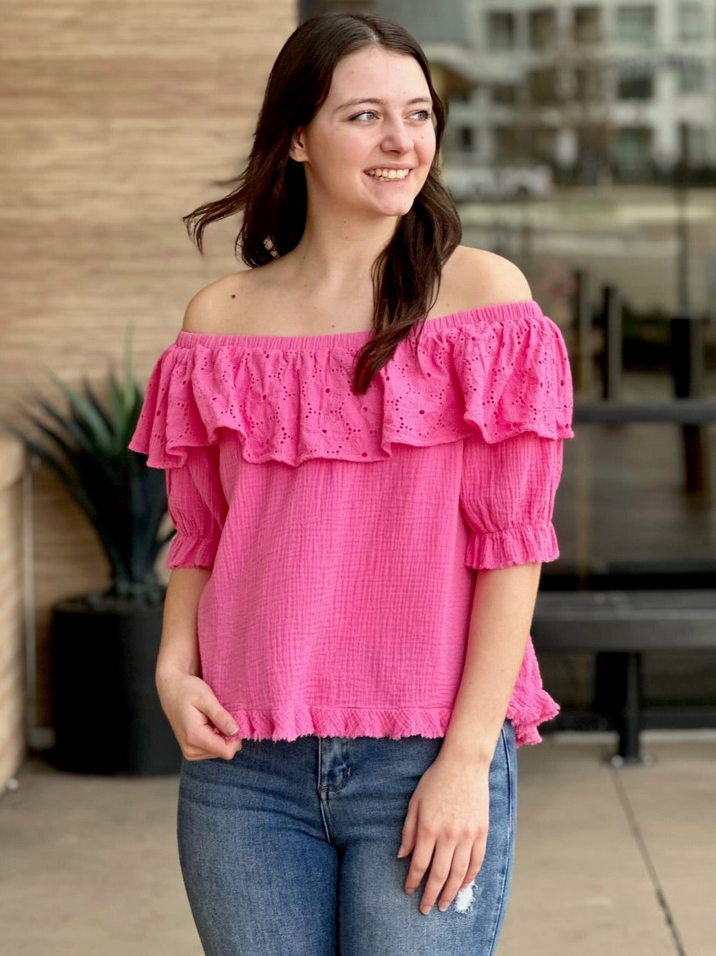 Megan in bubblegum blouse looking to the side