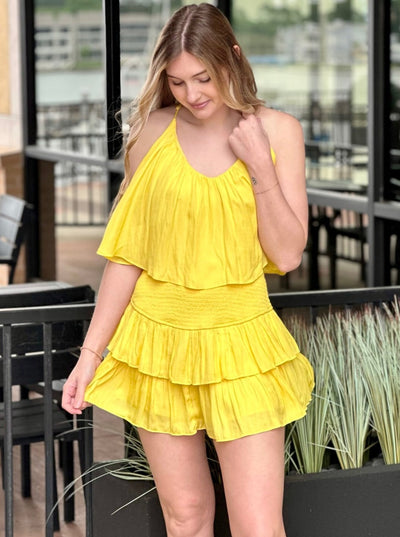 Lexi in yellow romper front view looking down