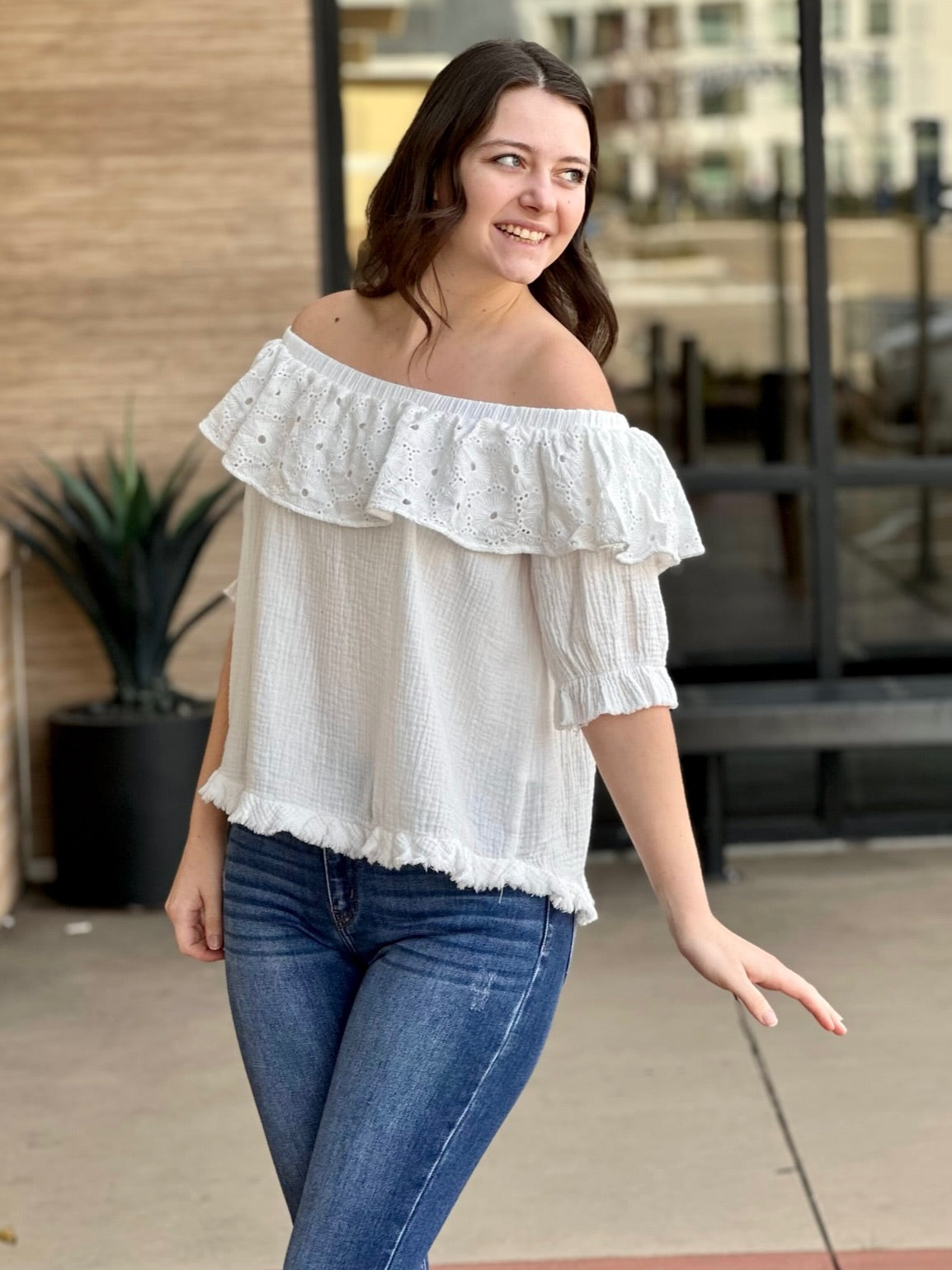 Megan in off white blouse looking to the side