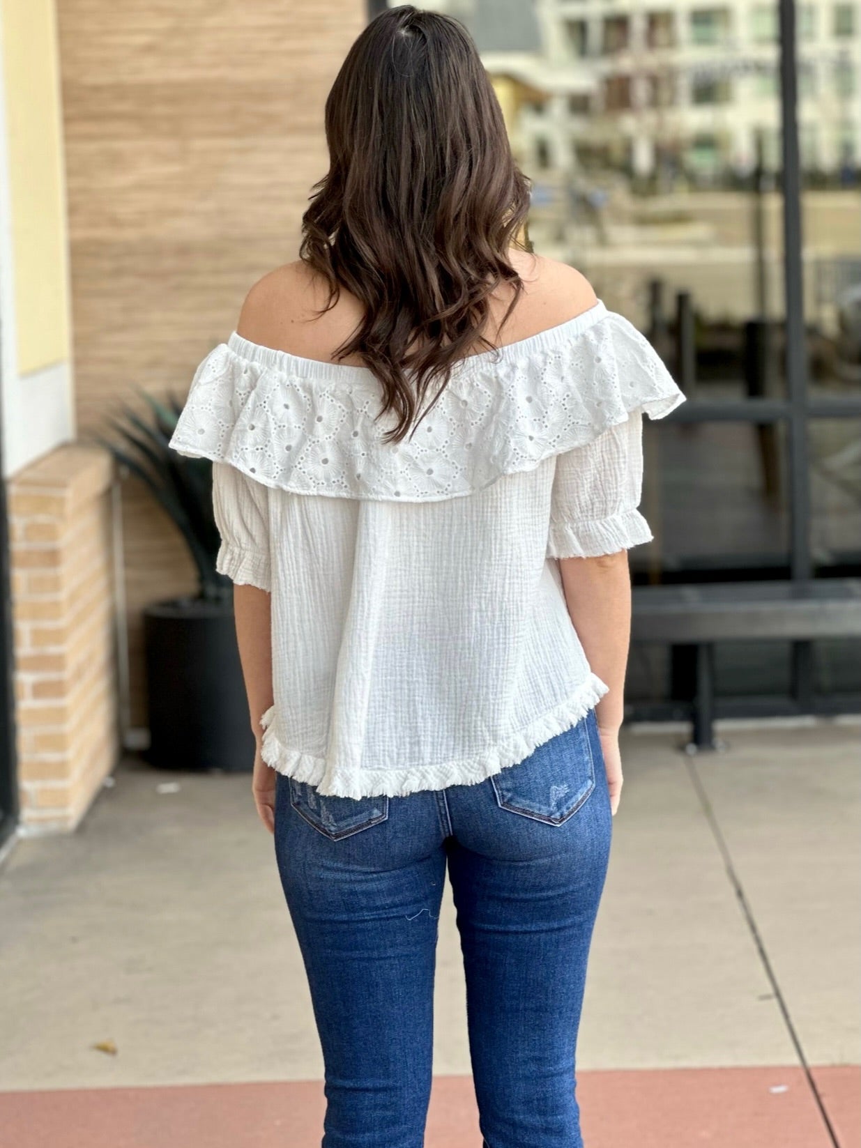 Megan in off white blouse back view