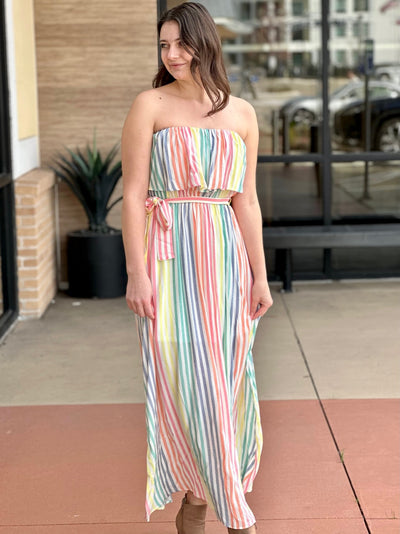 Megan in multi midi dress looking to the side hands down