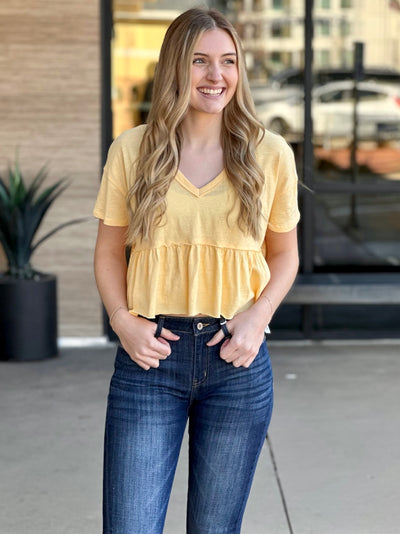 Lexi in creamy corn top looking to the side smiling