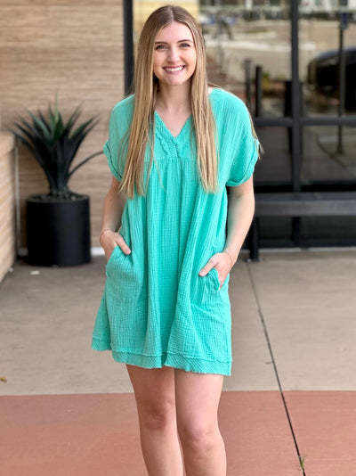 Lexi in mint dress front view both hands in pockets