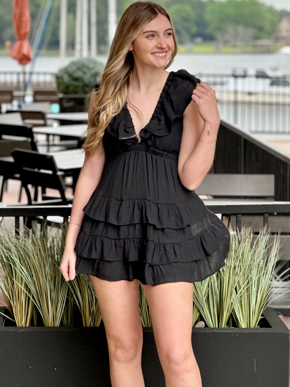 Lexi in black dress looking to the side